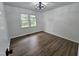 Bedroom with vinyl floors, ceiling fan and a large window that provides lots of natural light at 5920 Holly Dr, Raleigh, NC 27616