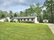 Well-maintained single-story home with a large green lawn, shed, and an inviting, suburban feel at 5920 Holly Dr, Raleigh, NC 27616