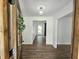 Bright foyer with wood-look floors leads into the home, showcasing modern lighting and open spaces at 5920 Holly Dr, Raleigh, NC 27616