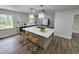 Bright, updated kitchen with pendant lights, stainless appliances, and island with counter seating at 5920 Holly Dr, Raleigh, NC 27616