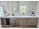 Kitchen area showcases a modern sink with gold faucet, cabinetry, and countertop at 5920 Holly Dr, Raleigh, NC 27616