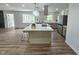Bright and updated kitchen with a large island, stainless steel appliances, and a view to the backyard at 5920 Holly Dr, Raleigh, NC 27616