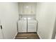 Clean laundry room with modern washer and dryer, and neutral color scheme at 5920 Holly Dr, Raleigh, NC 27616
