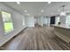 Bright living room features hardwood floors, recessed lighting, and large windows that offer lots of natural light at 5920 Holly Dr, Raleigh, NC 27616