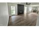 Open living room with wood floors, a modern fireplace, and bright windows, offering a comfortable living space at 5920 Holly Dr, Raleigh, NC 27616