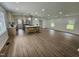 Bright living room with updated kitchen, large island, hardwood floors, and recessed lighting at 5920 Holly Dr, Raleigh, NC 27616