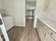 Mud room with sleek countertops, cabinetry, and laundry area leading to kitchen at 5920 Holly Dr, Raleigh, NC 27616