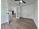Office space with vinyl floors and ceiling fan, framed by stylish french doors looking into the living area at 5920 Holly Dr, Raleigh, NC 27616