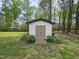 A well-maintained outbuilding set amidst a lush lawn, enhanced with landscaping and mature trees at 5920 Holly Dr, Raleigh, NC 27616