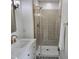Beautiful walk-in shower featuring gold hardware, intricate floors, and neutral tiling at 5920 Holly Dr, Raleigh, NC 27616