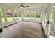 Bright sunroom featuring wood-look floors and multiple windows, perfect for enjoying views of the outdoor scenery at 5920 Holly Dr, Raleigh, NC 27616