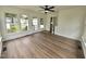Bright sunroom featuring a ceiling fan, multiple windows, and wood-look flooring at 5920 Holly Dr, Raleigh, NC 27616