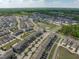 Expansive aerial view of a residential community with tree-lined streets and a pond in the distance at 6309 Truxton Ln, Raleigh, NC 27616