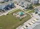 Aerial view of community garden with plots, covered seating, and nearby residential homes at 6309 Truxton Ln, Raleigh, NC 27616