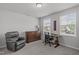 Comfortable bedroom with ample natural light, a plush chair, and a wooden dresser at 6309 Truxton Ln, Raleigh, NC 27616