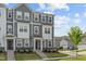 Charming townhome with gray siding, white trim, stone accents, and a well-manicured lawn at 6309 Truxton Ln, Raleigh, NC 27616