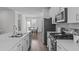 Bright kitchen with stainless steel appliances, white cabinetry, and modern finishes at 6309 Truxton Ln, Raleigh, NC 27616