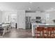 Bright open-concept kitchen featuring white cabinets, stainless steel appliances, and a large island with seating at 6309 Truxton Ln, Raleigh, NC 27616