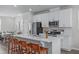 Modern kitchen features large island with bar seating, stainless steel appliances, and white cabinets at 6309 Truxton Ln, Raleigh, NC 27616