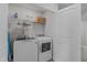 Functional laundry room with washer, dryer, and shelving for storage at 6309 Truxton Ln, Raleigh, NC 27616