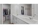 Modern main bathroom with double sinks, white cabinets, and walk-in closet at 6309 Truxton Ln, Raleigh, NC 27616