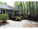 A patio leads to a deck to enjoy the quiet backyard with mature trees and landscaping at 6417 Meadow View Dr, Raleigh, NC 27609