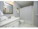 This bathroom has white cabinets, sink, toilet, and shower with gray walls at 6417 Meadow View Dr, Raleigh, NC 27609