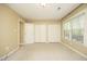 Bedroom features neutral carpet, natural light, and closets at 6417 Meadow View Dr, Raleigh, NC 27609