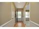 View of entryway with hardwood flooring, wainscotting, and door leading to another room at 6417 Meadow View Dr, Raleigh, NC 27609