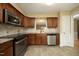 The kitchen features stainless steel appliances, tile backsplash, and granite countertops at 6417 Meadow View Dr, Raleigh, NC 27609