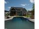 Beautiful backyard features an inviting pool, a built-in kitchen, and a relaxing pergola perfect for entertaining at 6521 Camellia Creek Dr, Raleigh, NC 27603