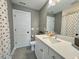 Bathroom with white vanity, quartz countertop, and a large mirror, providing a clean and bright space at 6521 Camellia Creek Dr, Raleigh, NC 27603