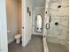 Modern bathroom featuring hexagon tile flooring, toilet and shower with marble tile and black fixtures at 6521 Camellia Creek Dr, Raleigh, NC 27603