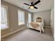 Comfortable bedroom with light gray walls, white trim, plush carpeting, and large windows for natural light at 6521 Camellia Creek Dr, Raleigh, NC 27603