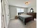 Cozy bedroom with neutral paint, carpet floors, dresser, closet, and a window providing natural light at 6521 Camellia Creek Dr, Raleigh, NC 27603