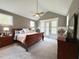 Inviting bedroom with a large bed, side tables, and French doors, offering comfort and style at 6521 Camellia Creek Dr, Raleigh, NC 27603