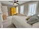 Comfortable bedroom with neutral paint, ceiling fan, plush carpeting, and two windows for natural light at 6521 Camellia Creek Dr, Raleigh, NC 27603