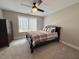 Bedroom featuring one window with lots of light, neutral walls, carpeted floor and a dark wood dresser at 6521 Camellia Creek Dr, Raleigh, NC 27603