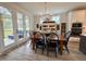 Cozy dining area with wood table, modern chandelier, and access to an outdoor patio at 6521 Camellia Creek Dr, Raleigh, NC 27603
