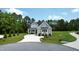Charming two-story home featuring gray siding, black roof, and manicured front lawn at 6521 Camellia Creek Dr, Raleigh, NC 27603