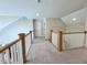 Bright hallway features neutral walls, plush carpet and wood and white railing at 6521 Camellia Creek Dr, Raleigh, NC 27603