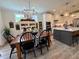 Cozy kitchen and dining area with wooden table and chairs and pendant lighting at 6521 Camellia Creek Dr, Raleigh, NC 27603