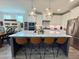 Bright, open kitchen with large island with seating, stainless steel appliances, and white cabinets at 6521 Camellia Creek Dr, Raleigh, NC 27603