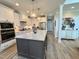 Modern kitchen with granite countertops, stainless steel appliances and an island with bar stools at 6521 Camellia Creek Dr, Raleigh, NC 27603