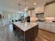 Open kitchen features island seating, granite counters, stainless appliances, and eat in dining at 6521 Camellia Creek Dr, Raleigh, NC 27603