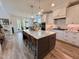 Bright, open kitchen with a spacious island, modern appliances, and white cabinets for a clean, contemporary feel at 6521 Camellia Creek Dr, Raleigh, NC 27603