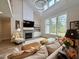 Inviting living room with fireplace, large windows, and neutral colors creating a serene atmosphere at 6521 Camellia Creek Dr, Raleigh, NC 27603