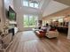 Bright living room boasts vaulted ceiling, large windows, fireplace and a modern chandelier at 6521 Camellia Creek Dr, Raleigh, NC 27603