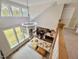 An open-concept living room with large windows, dining area, and a modern chandelier at 6521 Camellia Creek Dr, Raleigh, NC 27603