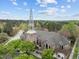 Stunning aerial view of a historic church with intricate stonework and a soaring spire at 700 Market St # 214, Chapel Hill, NC 27516